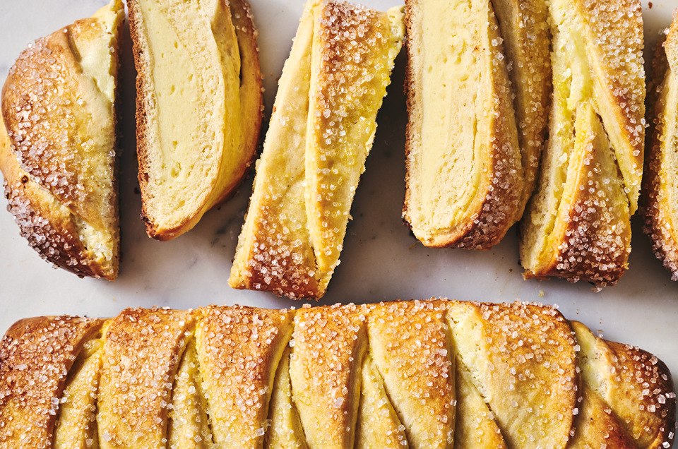 Cheese Filled Sweet Braid shown on a counter from above both sliced, and as a whole loaf. - select to zoom