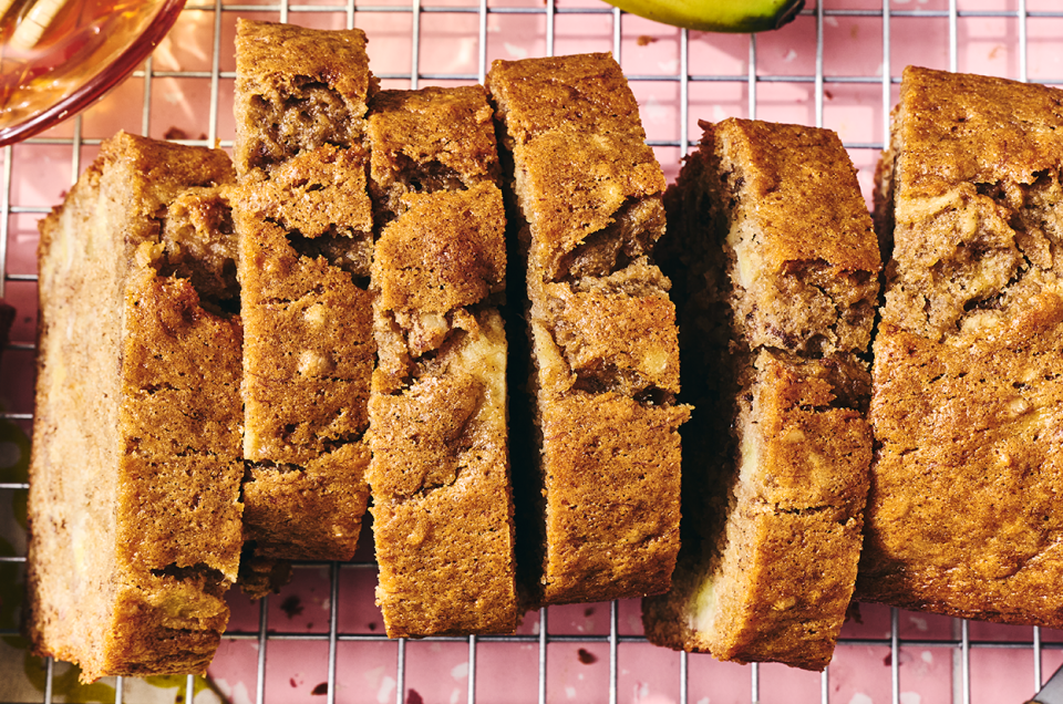 A loaf of Sourdough Banana Bread on a countertop sliced and seen from above. - select to zoom