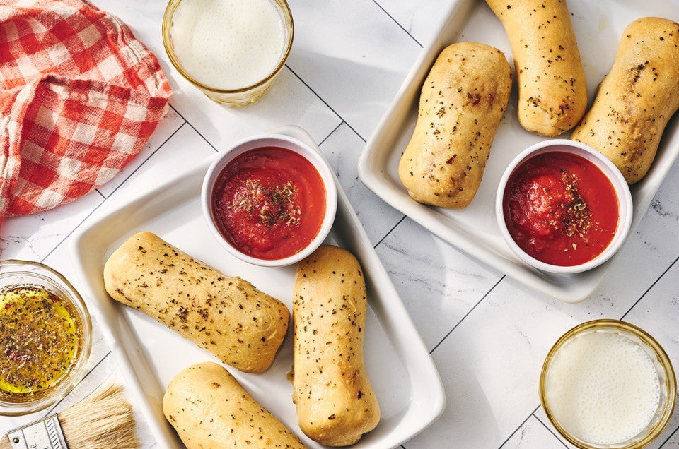Cheese Stuffed Breadsticks arranged on plates. - select to zoom
