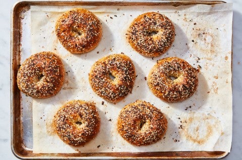 Sheet pan of baked Ultimate Sandwich Bagels with everything bagel topping