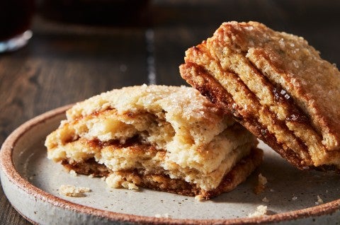 A Layered Fig Scone on a plate, broken in half, to reveal stripes of fig jam. - select to zoom