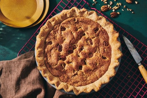 A Chocolate Chip Pecan Pie, freshly baked and on a kitchen table - select to zoom