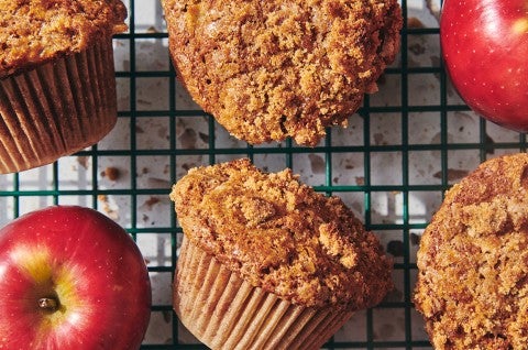 A close-up shot of freshly baked apple muffins on a cooling rack. - select to zoom