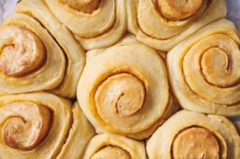 A close up overhead photo of Buttery Sourdough Buns with a swirl of paprika in them. - select to zoom