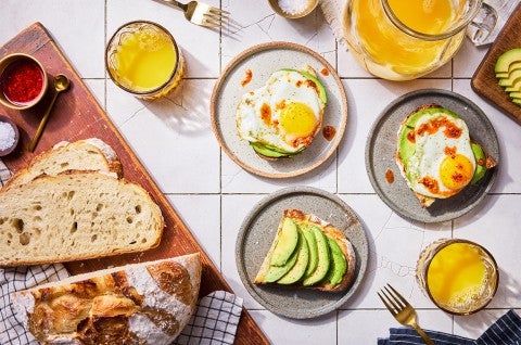 No-Knead Sourdough Bread on a cutting board with some avocado toast - select to zoom