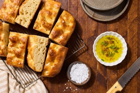Sourdough Focaccia on a cooling rack with olive oil and salt - select to zoom