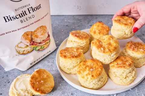 3-Ingredient Buttermilk Biscuits on a plate with a bag of flour - select to zoom