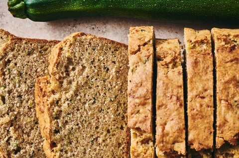 Almond Flour Zucchini Bread next to a zucchini - select to zoom