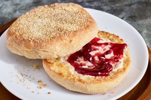 Gluten-Free Sourdough English Muffins made with Bread Flour sliced on a plate with butter and jam - select to zoom