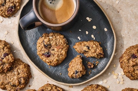 Oatmeal and Flax Cranberry Cookies on a plate with a cup of coffee - select to zoom