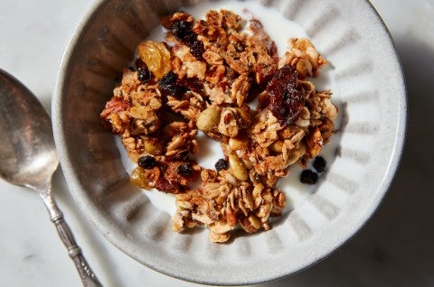 Crunchy granola clusters in a cereal bowl with milk