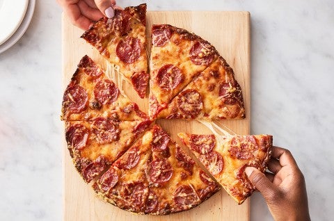 Easy Pan Pizza sliced up on a cutting board - select to zoom