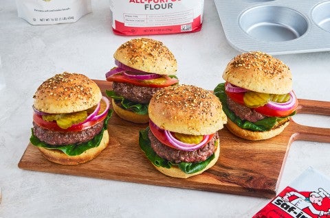 Four Hamburgers on a cutting board - select to zoom