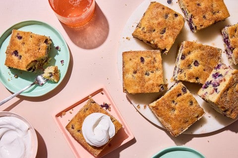 Easy Blueberry Muffin Cake served on a plate with whipped cream - select to zoom