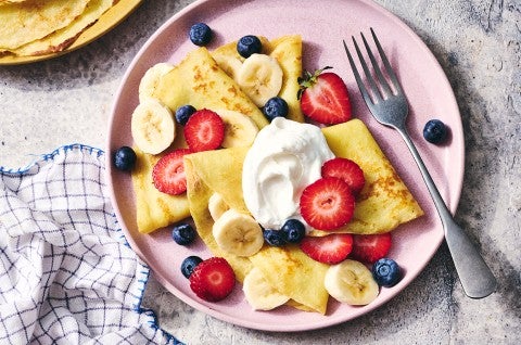 Gluten-Free Crêpes on a plate with berries and cream - select to zoom