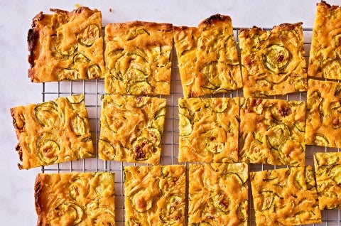 Scarpaccia (Italian Zucchini Tart) cut up on a cooling rack - select to zoom