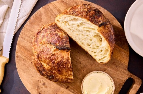 Croissant Sourdough Bread sliced and on a cutting board - select to zoom