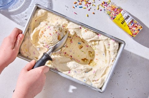 Scooping Birthday Cake Ice Cream out of the container - select to zoom