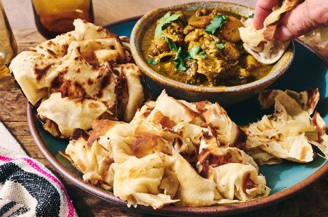 Buss Up Shut (Paratha Roti) being dipped - select to zoom