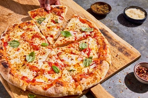 No-Knead Pizza Crust sliced on a cutting board - select to zoom