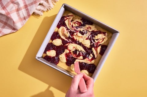 frangipane and raspberry jam being swirled