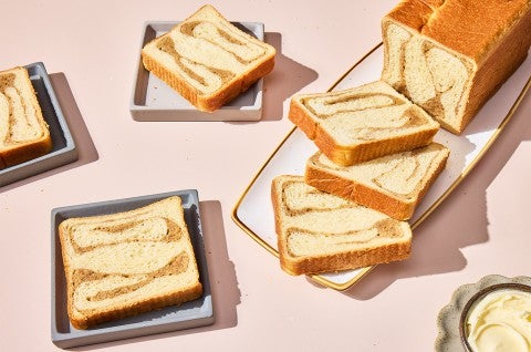 Swirled Maple Milk Bread on a cutting board and slices served on plates - select to zoom