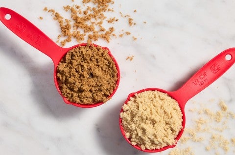 Dry measuring cups full of light and dark brown sugar