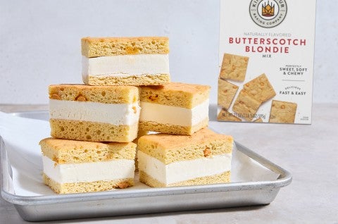 Butterscotch Blondie Ice Cream Sandwiches stacked high on a sheet pan - select to zoom