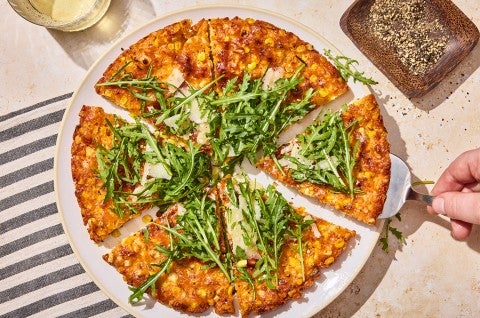 A Giant Cheesy Corn Fritter that has been sliced into pieces - select to zoom