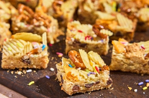 Cut-up pieces of Kitchen Sink Cookie Bars on a counter - select to zoom