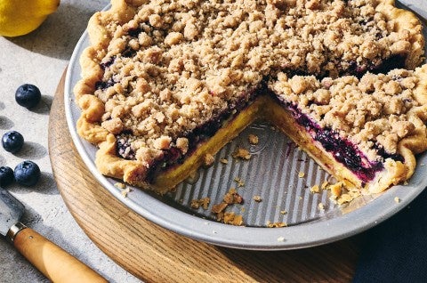 Lemon-Blueberry Streusel Pie in a pie dish with a slice removed - select to zoom