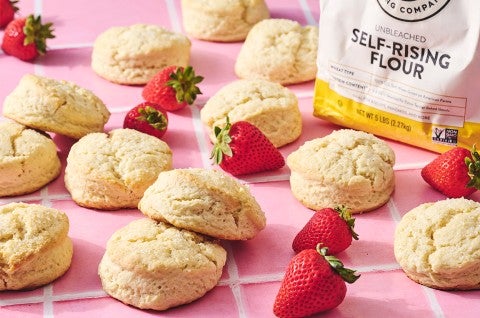 Self-Rising Cream Biscuits on a counter with strawberries - select to zoom