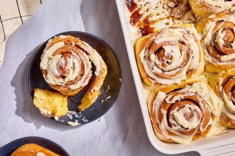 A Sweet Potato Cinnamon Roll on a plate; a bunch in a casserole dish - select to zoom