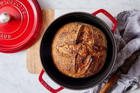 Loaf of bread baked in a red Dutch oven