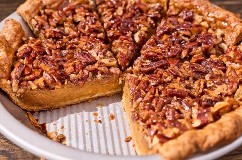Photograph of pumpkin pecan pie in a pie tin with a slice missing. - select to zoom