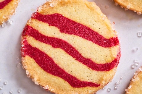 Photograph of a single striped shortbread peppermint cookie from the top. - select to zoom
