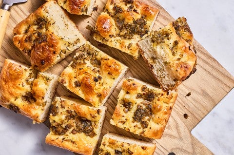 Top down view of stuffing focaccia chunks on a cutting board. - select to zoom