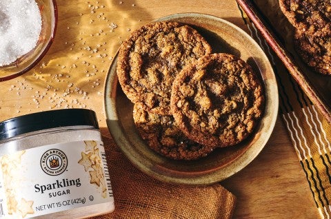 Cape Cod Soft Molasses Cookies shown on a plate with King Arthur Baking's Sparkling Sugar in the bottom left corner of the frame. - select to zoom