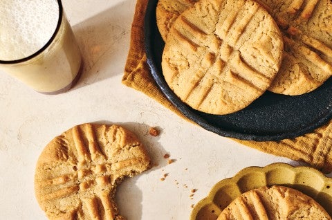 Detailed shot of a few Classic Peanut Butter Cookies seen from above - one cookie has a bite taken out of it. - select to zoom