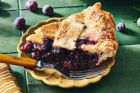 Concord Grape Pie seen from the side with dark blue and purple filling. - select to zoom