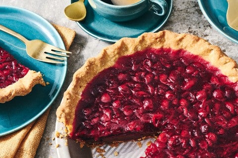 Cranberry-Fudge Pie in a pie tin with a slice removed. - select to zoom
