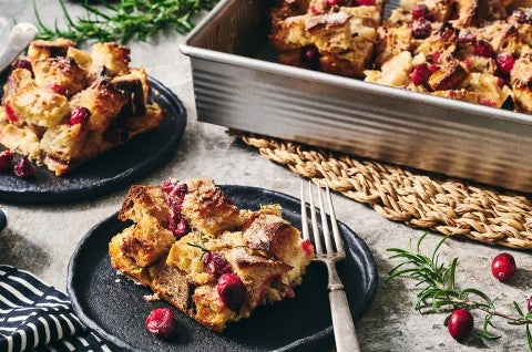 Cranberry-Rosemary Breakfast Bread Pudding on plates and in a pan. - select to zoom