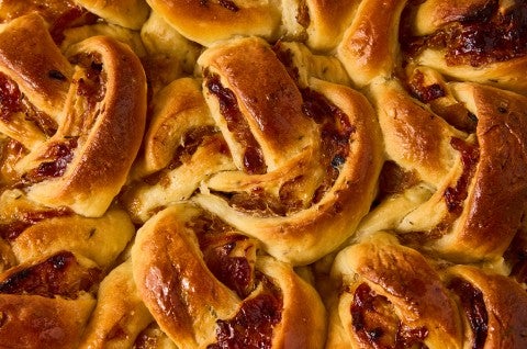 A detail shot of French Onion Rolls showing golden baked roll layers and caramelized onions. - select to zoom