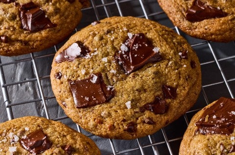 Beautifully baked High-Altitude Chocolate Chip Cookies fresh out of the oven on a cooling rack. - select to zoom