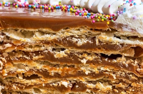 Detailed photograph of the interior of Torta Chilena showing layers of dulce de leche and crispy pastry stacked together. - select to zoom