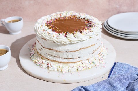 A simple and elegant decorated Torta Chilena with white creme fraiche frosting and dulce de leche on top. - select to zoom