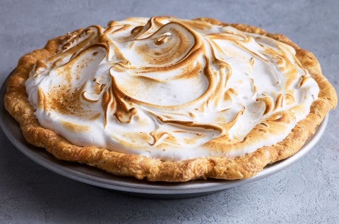 Swirled, baked, and lightly browned Swiss meringue atop a freshly baked pie. - select to zoom
