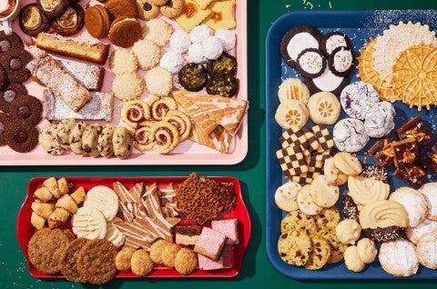 Three platters with many different varieties of cookies