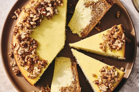 Carrot Cake Cheesecake with golden creamy cheesecake and edged with walnuts. - select to zoom