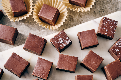 Easy Microwave Fudge cut into neat squares and shown on a light colored marble counter. - select to zoom